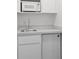 Modern kitchenette features a microwave, sink, and mini refrigerator at 17728 Se 115Th Ct, Summerfield, FL 34491