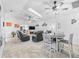 Spacious open-concept living area with a fireplace, ceiling fans, and lots of natural light at 17728 Se 115Th Ct, Summerfield, FL 34491