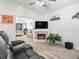 Cozy living room with a fireplace, perfect for relaxing or entertaining guests at 17728 Se 115Th Ct, Summerfield, FL 34491