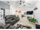 Comfortable living room features a fireplace, modern furniture, and seamless access to dining area at 17728 Se 115Th Ct, Summerfield, FL 34491