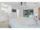 Open Primary bedroom with a king bed, tv, and access to the screened pool area at 17728 Se 115Th Ct, Summerfield, FL 34491