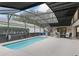 Screened-in pool area with a sparkling pool, comfortable seating, and outdoor lighting at 17728 Se 115Th Ct, Summerfield, FL 34491