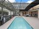 Full view of the caged in pool and patio area, with ample room for outdoor furniture at 17728 Se 115Th Ct, Summerfield, FL 34491