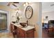 Bathroom vanity featuring dual vessel sinks, granite countertops, and wood cabinetry at 1945 Maple Cir # 45E, Tavares, FL 32778