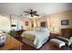Charming bedroom with hardwood floors, ceiling fan, and ample natural light at 1945 Maple Cir # 45E, Tavares, FL 32778