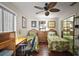Well-lit bedroom with hardwood floors, ceiling fan, and closet at 1945 Maple Cir # 45E, Tavares, FL 32778