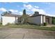 A beautiful side view of the home featuring mature landscaping with an attached two-car garage at 1945 Maple Cir # 45E, Tavares, FL 32778