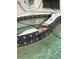Close-up of tiled in-ground hot tub with tile detail and spill-over feature into the main pool at 1945 Maple Cir # 45E, Tavares, FL 32778