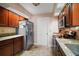 Well-lit kitchen featuring stainless steel appliances, granite countertops, and classic wood cabinetry at 1945 Maple Cir # 45E, Tavares, FL 32778