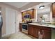 Kitchen view featuring stainless appliances, granite countertops, a view into the dining room and tile floors at 1945 Maple Cir # 45E, Tavares, FL 32778