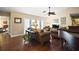 Cozy living room featuring hardwood floors, a piano, and inviting seating arrangement at 1945 Maple Cir # 45E, Tavares, FL 32778