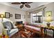 Comfortable living room with hardwood floors, ceiling fan, and natural light at 1945 Maple Cir # 45E, Tavares, FL 32778