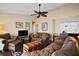 Inviting living room with ceiling fan, rich hardwood floors, and comfortable seating at 1945 Maple Cir # 45E, Tavares, FL 32778