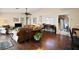 Spacious living room with hardwood floors, comfortable seating, piano, and view of dining area at 1945 Maple Cir # 45E, Tavares, FL 32778