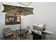 Cozy outdoor patio with grill, table, chairs, and umbrella ideal for relaxing or outdoor dining at 1945 Maple Cir # 45E, Tavares, FL 32778