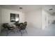 Covered and enclosed patio area featuring an outdoor dining set at 1945 Maple Cir # 45E, Tavares, FL 32778