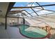 Enclosed pool area with a waterfall feature, and an angular ceiling at 1945 Maple Cir # 45E, Tavares, FL 32778