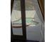 Inviting screened-in pool and spa area with lush landscaping, viewed from inside the home at 1945 Maple Cir # 45E, Tavares, FL 32778