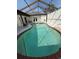 Enclosed in-ground pool with surrounding patio and partial outdoor kitchen, great for outdoor living at 1945 Maple Cir # 45E, Tavares, FL 32778