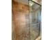 Updated shower with stone look tiles, glass door and chrome shower head at 1945 Maple Cir # 45E, Tavares, FL 32778