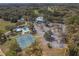 Aerial view of community, showing a pool, tennis courts, parking and landscaping at 19666 Sw 88Th Loop, Dunnellon, FL 34432