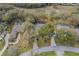 Aerial view of the property showcasing the home's layout, surrounding greenery, and proximity to neighbors at 19666 Sw 88Th Loop, Dunnellon, FL 34432