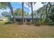 View of the back of the home showing a patio, screened-in pool, and landscaped backyard at 19666 Sw 88Th Loop, Dunnellon, FL 34432