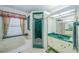 This bathroom features a tub, a shower, a vanity with mirror and a decorative window at 19666 Sw 88Th Loop, Dunnellon, FL 34432
