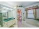 Well-lit bathroom with tub and shower, features a window and decorative elements at 19666 Sw 88Th Loop, Dunnellon, FL 34432