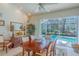 Dining room with a view of the screened-in pool and outdoor area at 19666 Sw 88Th Loop, Dunnellon, FL 34432