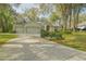 A large driveway leads to a well-maintained home with a spacious three-car garage at 19666 Sw 88Th Loop, Dunnellon, FL 34432