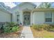 Charming home entrance with stone archway, landscaped garden, and walkway at 19666 Sw 88Th Loop, Dunnellon, FL 34432