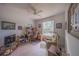 A cozy home office features a ceiling fan, a window and built-in shelving at 19666 Sw 88Th Loop, Dunnellon, FL 34432