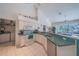 Kitchen featuring white cabinets, green countertops, and stainless steel appliances at 19666 Sw 88Th Loop, Dunnellon, FL 34432