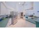 Bright kitchen with a stainless steel refrigerator, white cabinets, and green counters at 19666 Sw 88Th Loop, Dunnellon, FL 34432