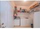 Utility room equipped with a washer, dryer, sink and shelving at 19666 Sw 88Th Loop, Dunnellon, FL 34432
