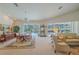 Bright living and dining area with large windows overlooking the screened-in pool at 19666 Sw 88Th Loop, Dunnellon, FL 34432