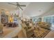 Bright and airy living room with a ceiling fan, tile flooring, and a view of the pool at 19666 Sw 88Th Loop, Dunnellon, FL 34432