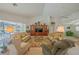Spacious living room with comfortable seating, large windows, and a ceiling fan at 19666 Sw 88Th Loop, Dunnellon, FL 34432