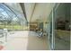 Large screened-in patio with ceiling fan and comfortable outdoor seating at 19666 Sw 88Th Loop, Dunnellon, FL 34432