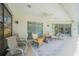 Outdoor patio with palm tree rug, ceiling fan, and comfortable seating at 19666 Sw 88Th Loop, Dunnellon, FL 34432