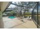 Exterior image of a screened pool and patio area with chairs and tables at 19666 Sw 88Th Loop, Dunnellon, FL 34432