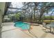 Screened pool with jacuzzi, patio furniture, and manicured landscaping at 19666 Sw 88Th Loop, Dunnellon, FL 34432