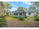 A lush landscaped backyard featuring a screened-in pool and patio at 19666 Sw 88Th Loop, Dunnellon, FL 34432