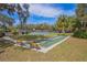 Outdoor shuffleboard court surrounded by benches, landscaping, and a tennis court at 19666 Sw 88Th Loop, Dunnellon, FL 34432