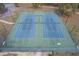 Aerial view of tennis courts, featuring lighting and surrounded by a secure fence at 19666 Sw 88Th Loop, Dunnellon, FL 34432
