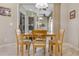 Cozy dining area with a light wood table and tan upholstered chairs, illuminated by pendant lighting at 2030 Bayside Ave, Mount Dora, FL 32757