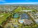 Stunning aerial view of the community's golf course, pool, tennis courts, and amenities at 2136 Kerwood Loop, The Villages, FL 32162