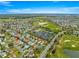 Aerial view showing home location marked by red arrow among the community landscape at 2136 Kerwood Loop, The Villages, FL 32162