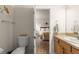 A quaint powder room with a toilet and a view to the Primary bedroom at 2136 Kerwood Loop, The Villages, FL 32162